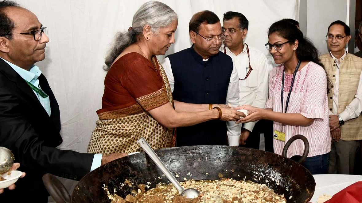 Union Minister for Finance and Corporate Affairs Nirmala Sitharaman distributes halwa to staff members of the finance ministry.