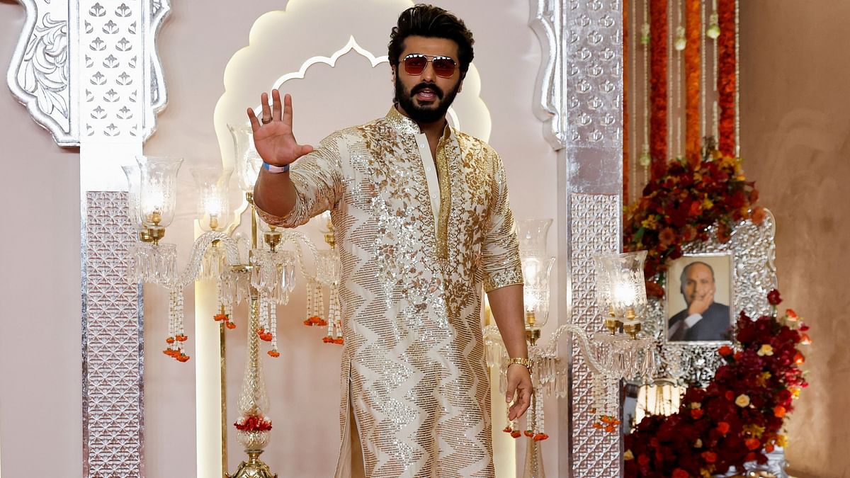 Arjun Kapoor gestures as he arrives for Anant Ambani and Radhika Merchant's wedding.