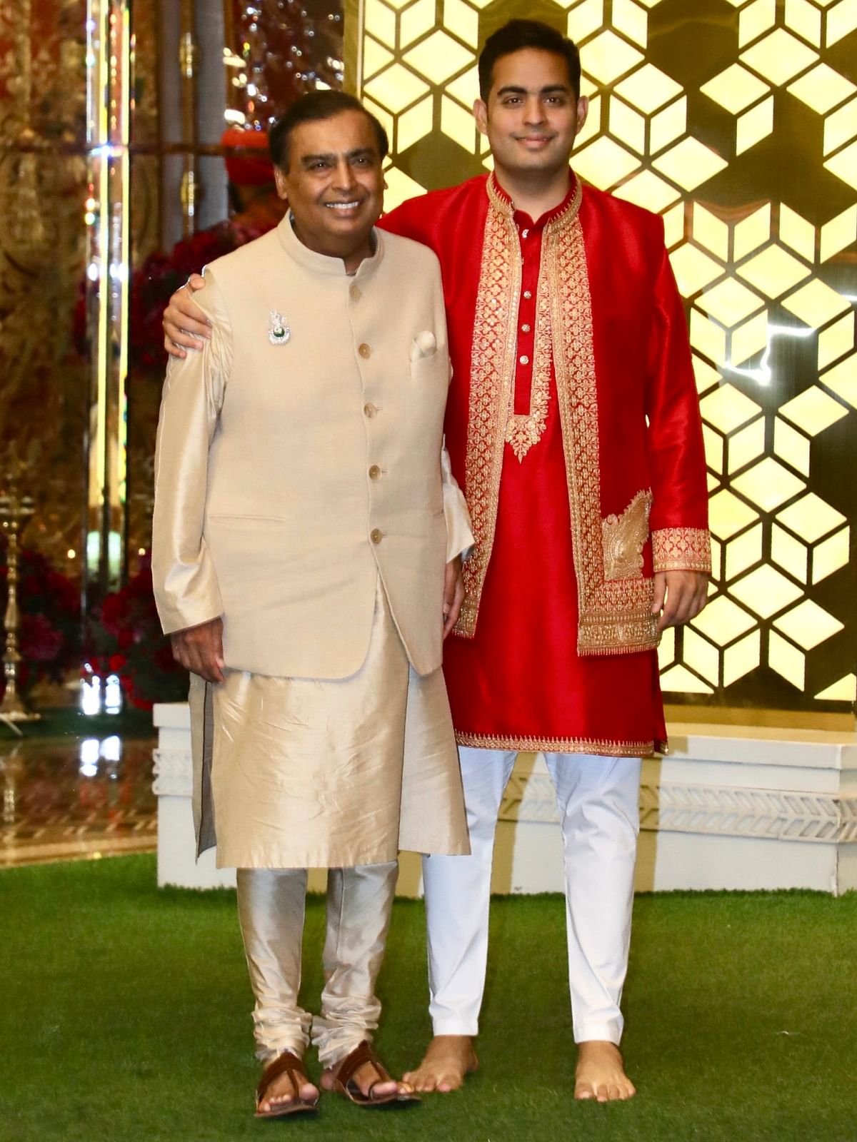 Mukesh Ambani poses with his son Akash Ambani during the Haldi ceremony of Anant Ambani and Radhika Merchant, in Mumbai.