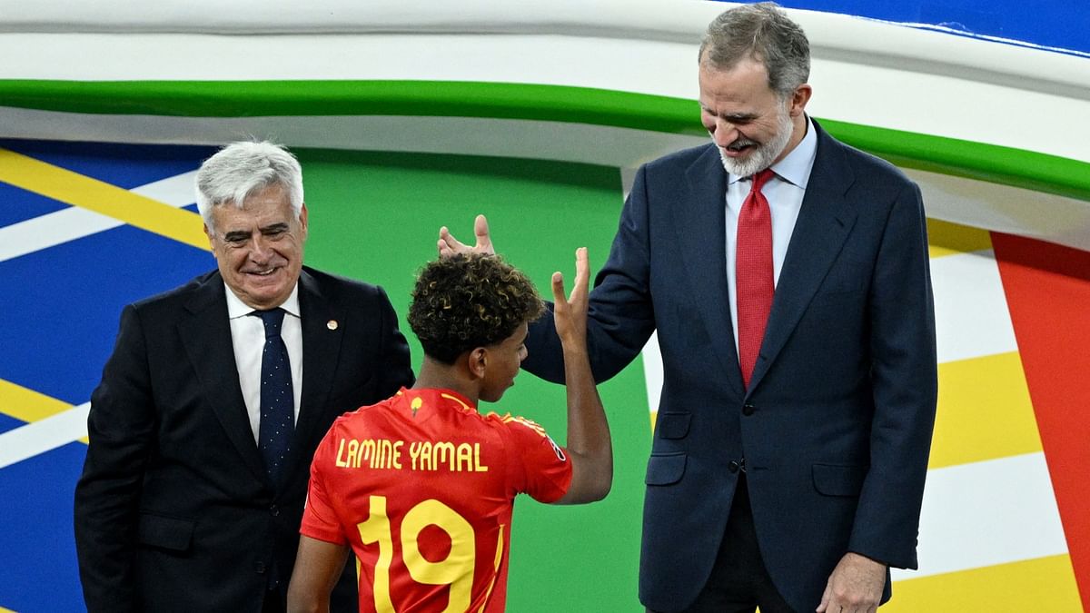 King Felipe VI of Spain and president of the Royal Spanish football federation Pedro Rocha shake hands with Lamine Yamal after the final.