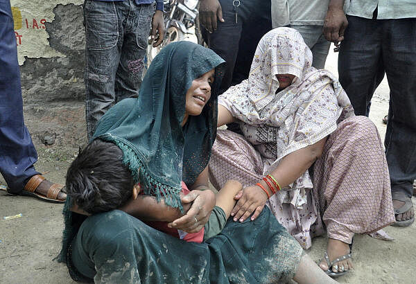 A woman is consoled as she mourns after her son died in a stampede outside a hospital in Hathras district in the northern state of Uttar Pradesh, India, July 2, 2024.