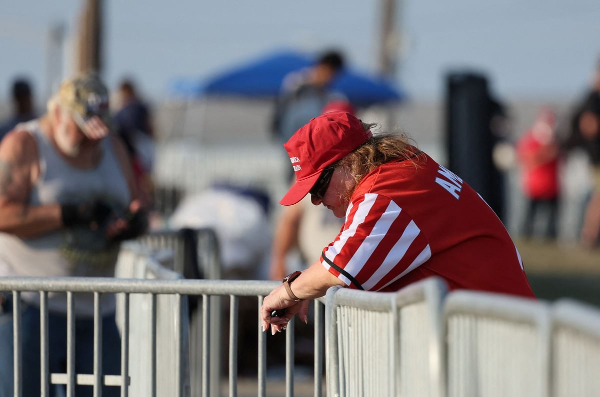 A supporter of Republican presidential candidate and former U.S. President Donald Trump reacts after multiple gunshots rang out at Republican presidential candidate and former U.S. President Donald Trump's campaign rally at the Butler Farm Show in Butler.