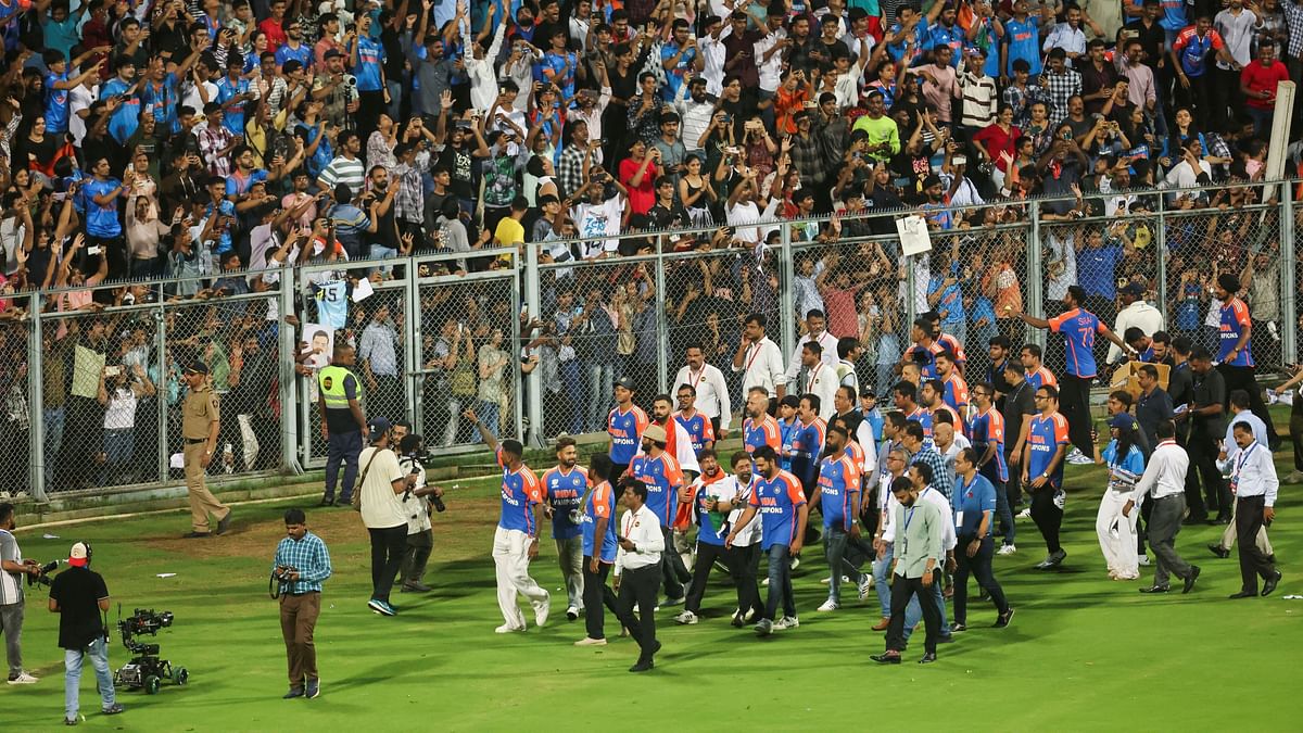 Indian cricket team players celebrate as they take a victory lap around the Wankhede stadium after winning the ICC men's T20 World Cup, in Mumbai.