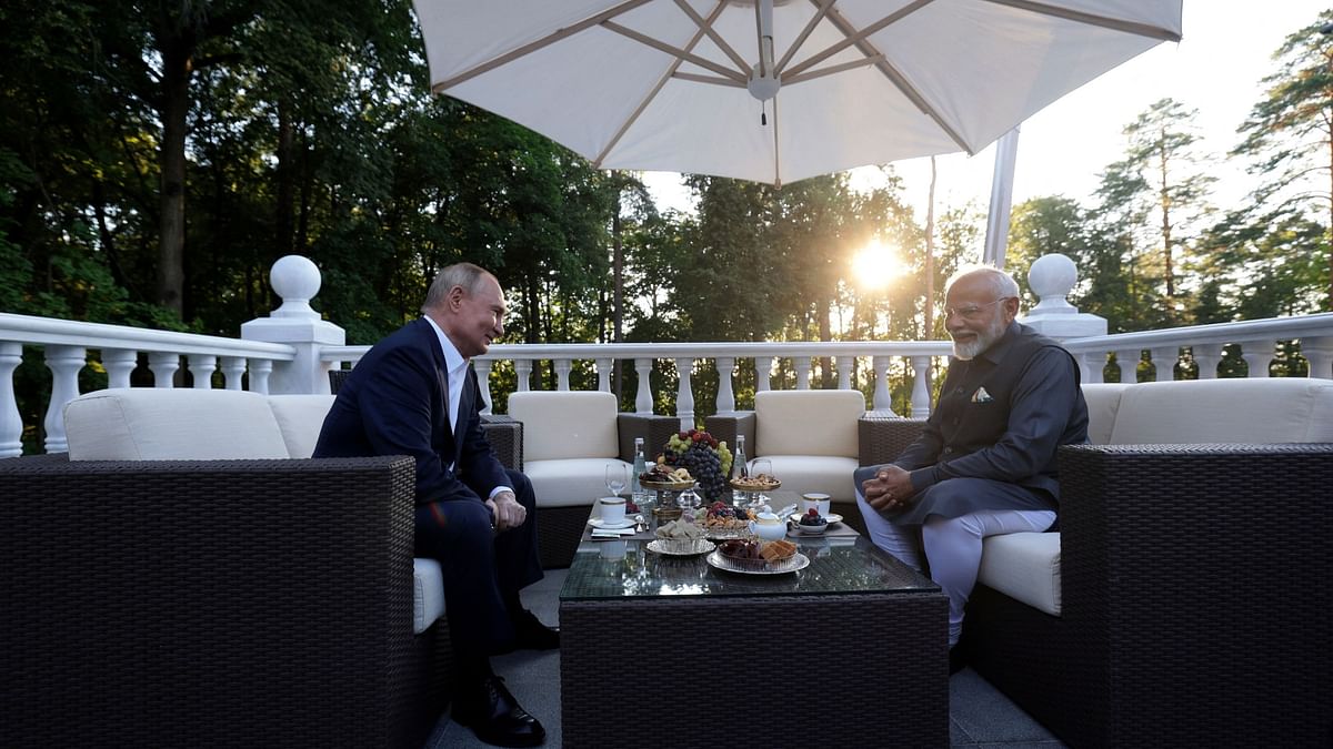 Vladimir Putin and Narendra Modi enjoy  tea on a terrace during a meeting at the Novo-Ogaryovo state residence near Moscow, Russia.