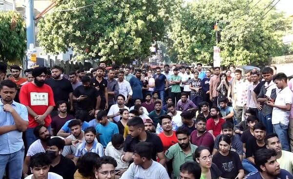 Students stage a protest over the death of three civil services aspirants after the basement of a coaching centre was flooded following heavy rain.