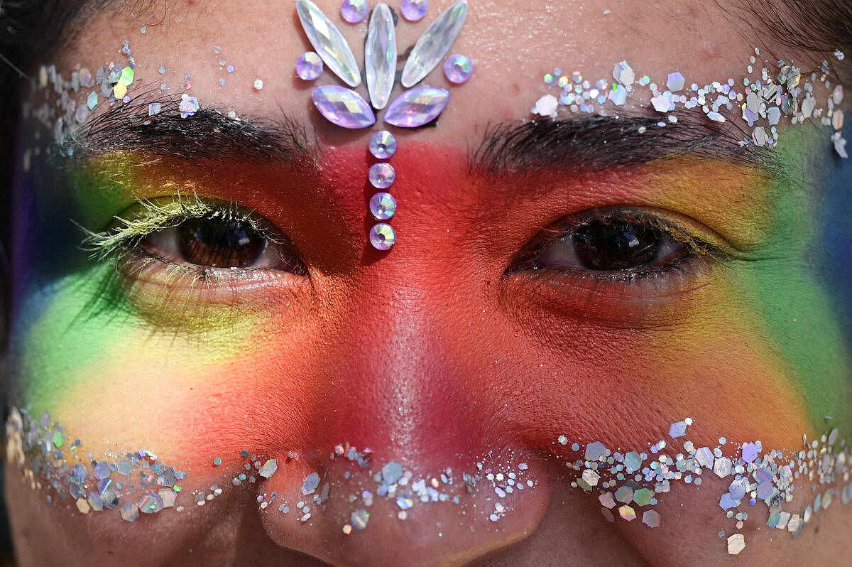 A reveler looks on as members of the LGBTQ+ community take part in the Latin American Gay Pride parade, in Caracas, Venezuela. 