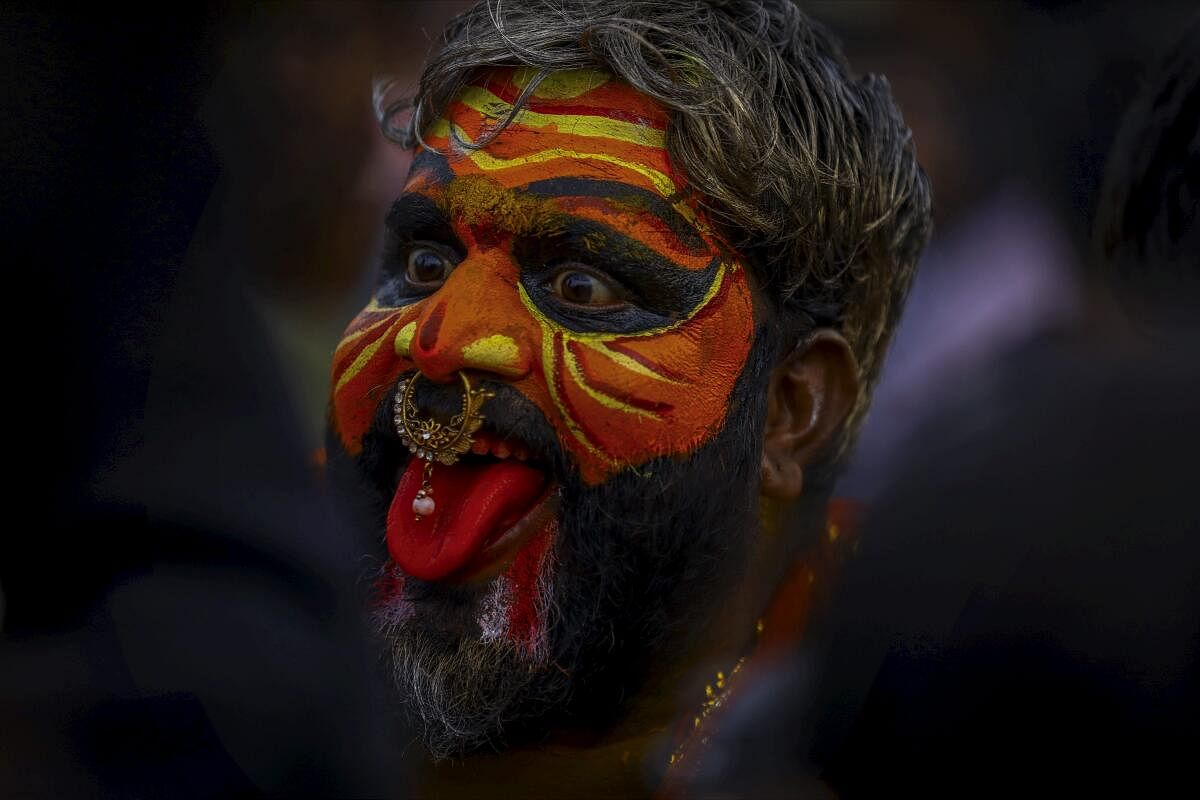 A devotee dressed as Potharaju performs during the ‘Ashada Bonalu’ festival, at the Golconda Fort. 