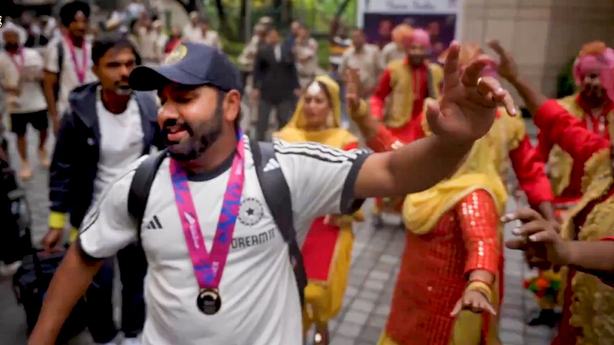 Indian cricket team captain Rohit Sharma dances with artists upon his arrival at a hotel in New Delhi.