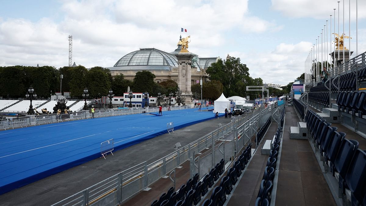 Workers prepare the Triathlon piste on the Pont Alexandre III bridge, in Paris.