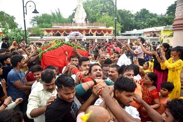 Devotees take part in ‘Palki Yatra’ on the eve of the annual Rath Yatra festival, in Varanasi.