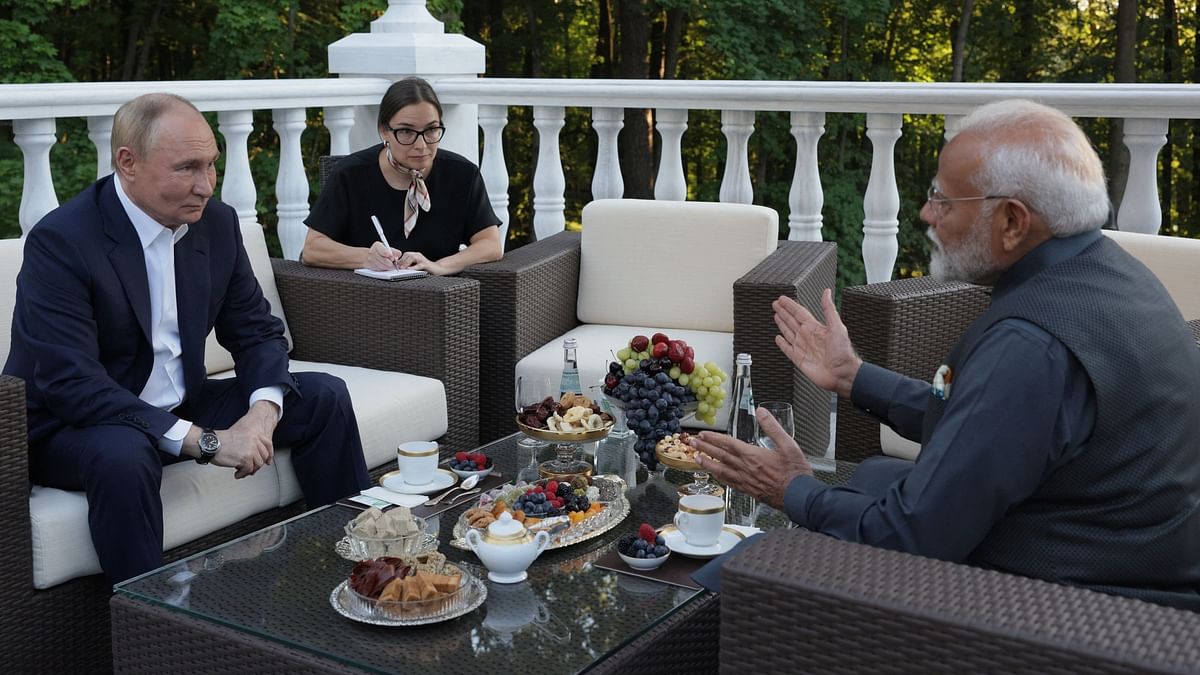 Vladimir Putin and Narendra Modi enjoy  tea on a terrace during a meeting at the Novo-Ogaryovo state residence near Moscow, Russia.