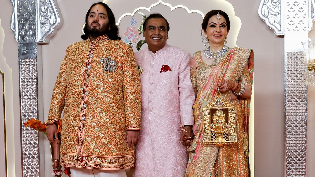 The groom Anant Ambani poses with parents Mukesh Ambani and Nita Ambani.