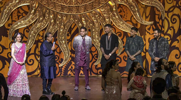 Reliance Industries Chairman Mukesh Ambani, his wife Nita Ambani and son Akash Ambani with Indian cricketers Rohit Sharma, Hardik Pandya and Suryakumar Yadav during Anant Ambani and Radhika Merchant’s 'Sangeet' ceremony, in Mumbai.