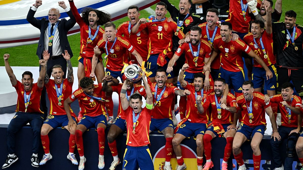 Spain's Alvaro Morata lifts the trophy as the team celebrates their Euro 2024 win.