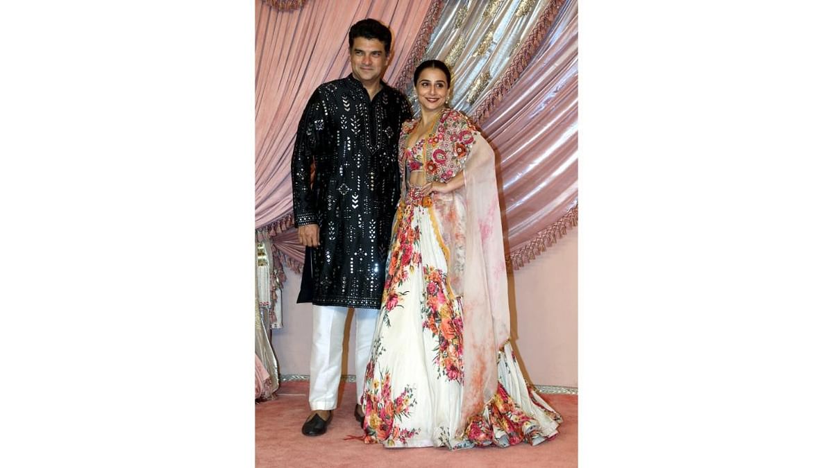 Bollywood producer Siddharth Roy Kapur and Vidya Balan pose together as they arrive for the Sangeet ceremony.