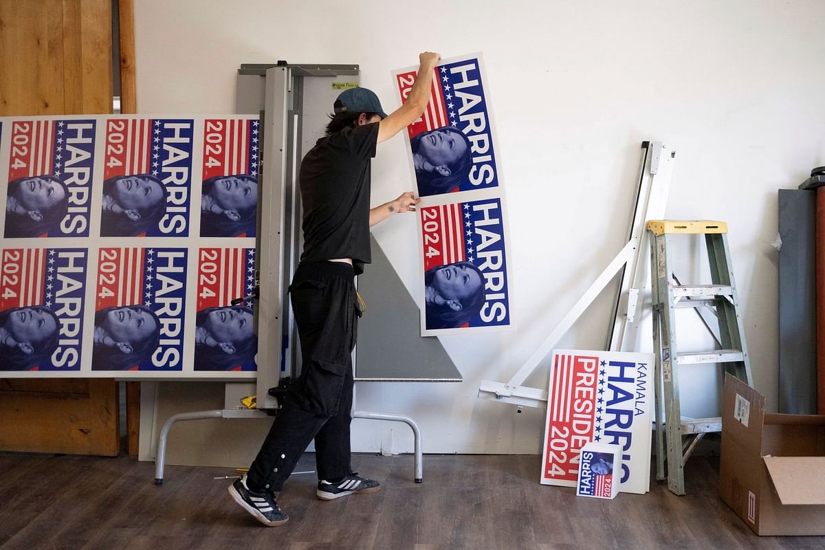 Print production specialist Aaron Miller cuts a run of 100 yard signs in support of U.S. Vice President Kamala Harris' presidential campaign at the Gloo Factory in Tucson, Arizona, U.S. July 25, 2024.