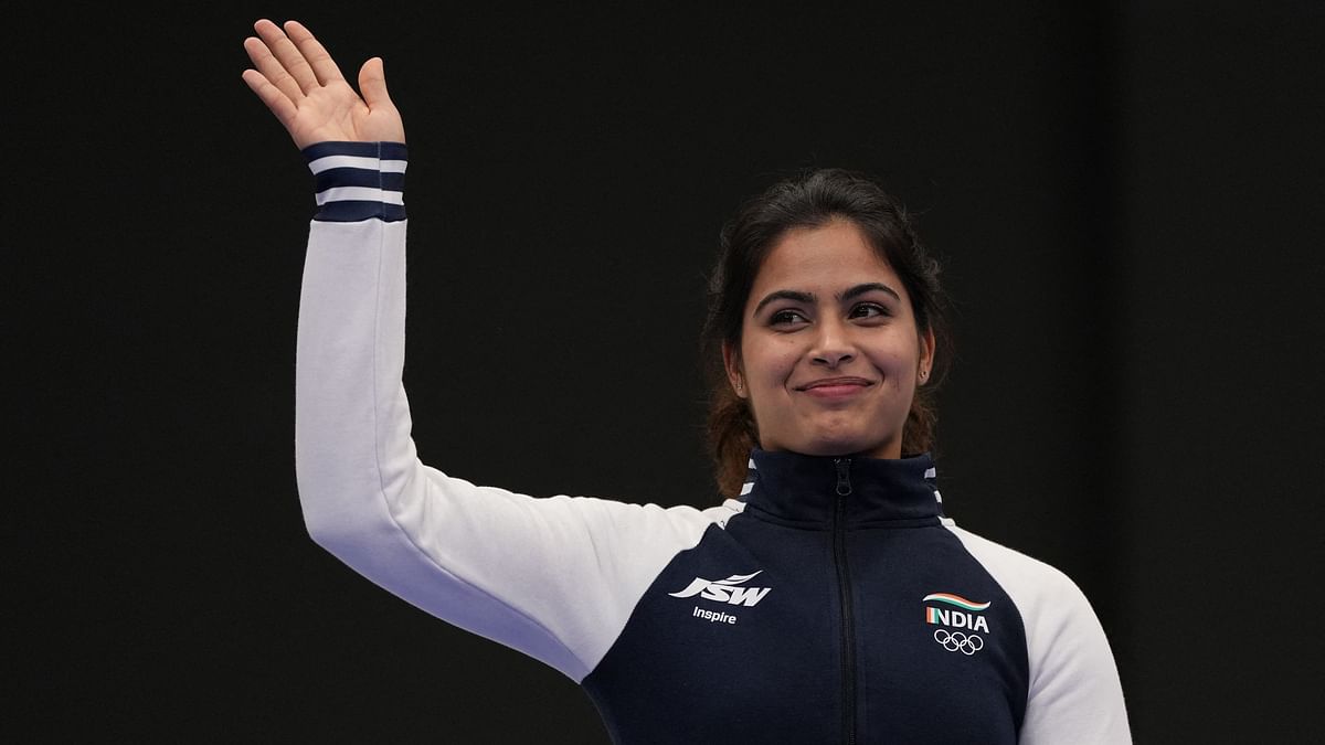 Bronze medallist Manu Bhaker waves during the ceremony.