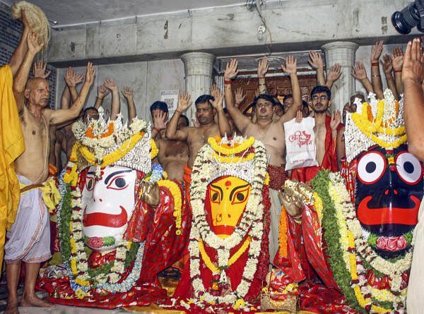 Priests perform rituals on the eve of the annual Rath Yatra festival, at the Jagannath Temple, in Ranchi.