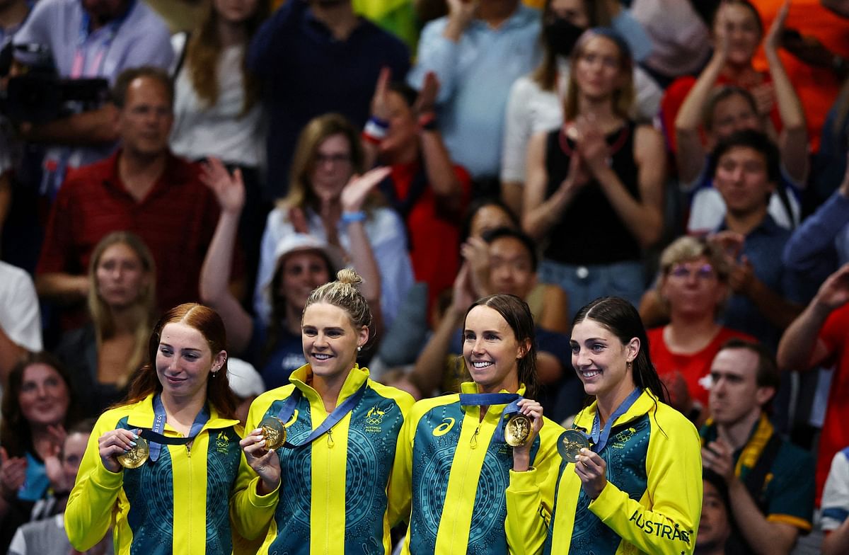 Gold medallists Mollie O'Callaghan of Australia, Emma McKeon of Australia, Meg Harris of Australia, Shayna Jack of Australia celebrate on the podium after winning the race.