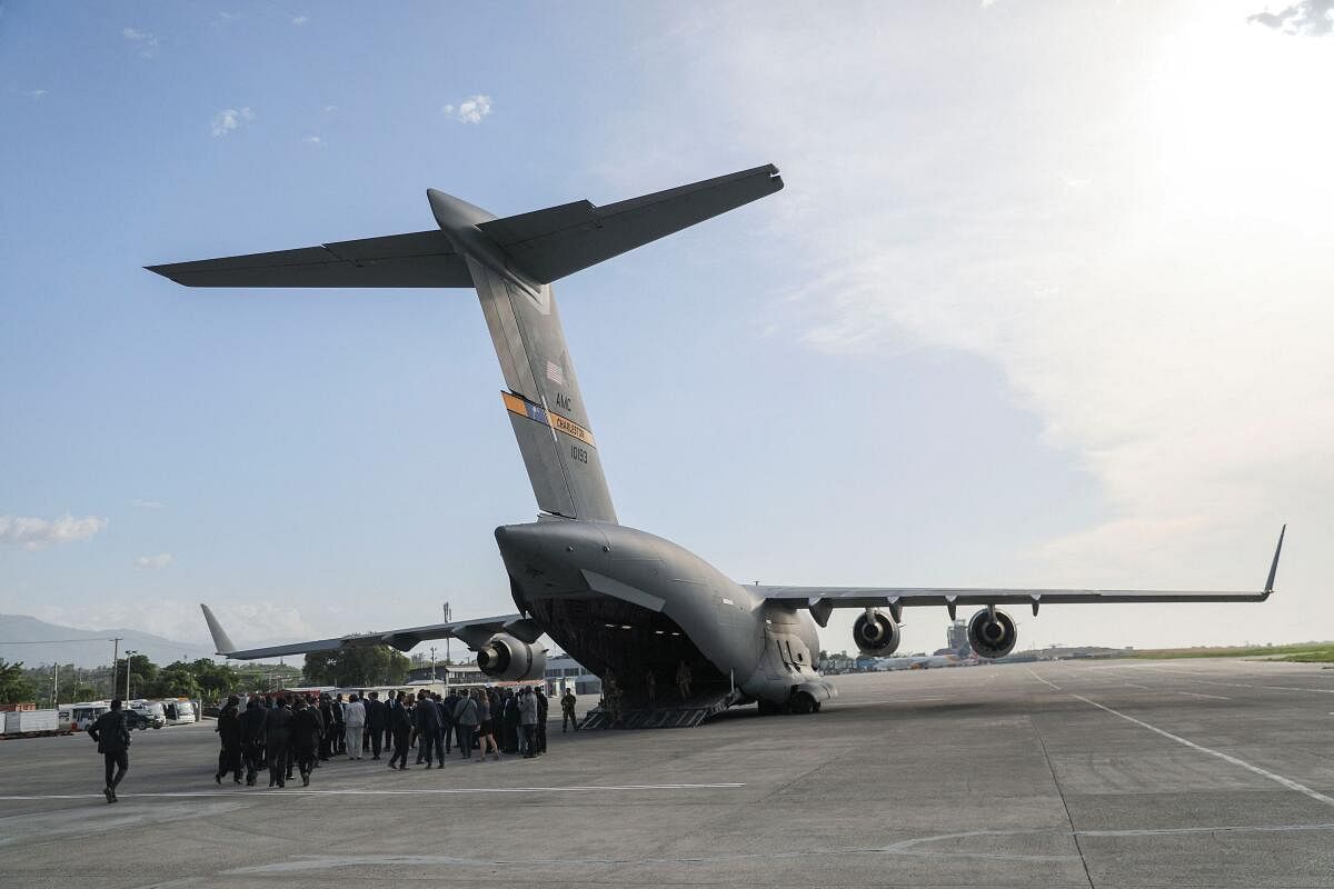 The entourage of the U.S. Ambassador to the United Nations Linda Thomas-Greenfield prepares to board a plane after a visit to Haiti at the Kenyan police base, in Port-au-Prince, Haiti.