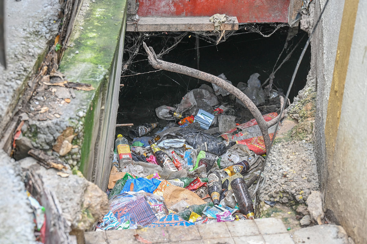 Plastic waste beer bottles and cloth waste are frequently dumped into the stormwater drain. DH Photos/S K Dinesh