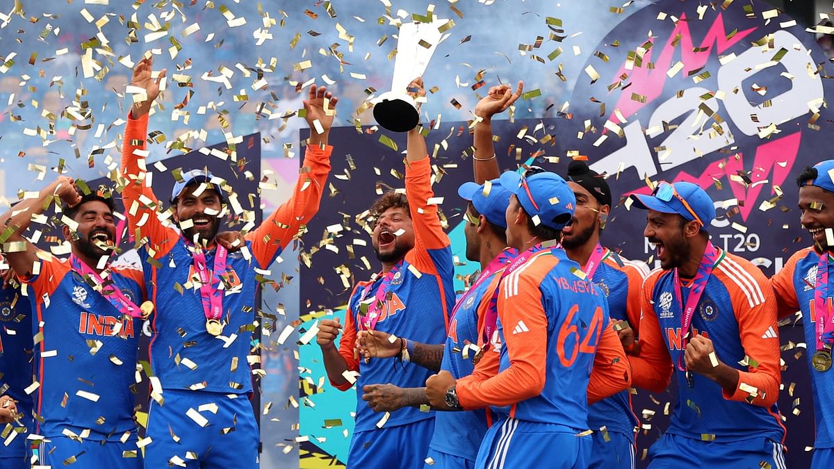 Kuldeep Yadav lifts the trophy as Team India players roar.