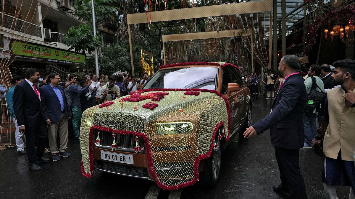 Anant set off from Antilia in a luxurious red car covered in strings of white flowers for the convention centre, where the 'baraat' assembled for a short journey to the mandap.