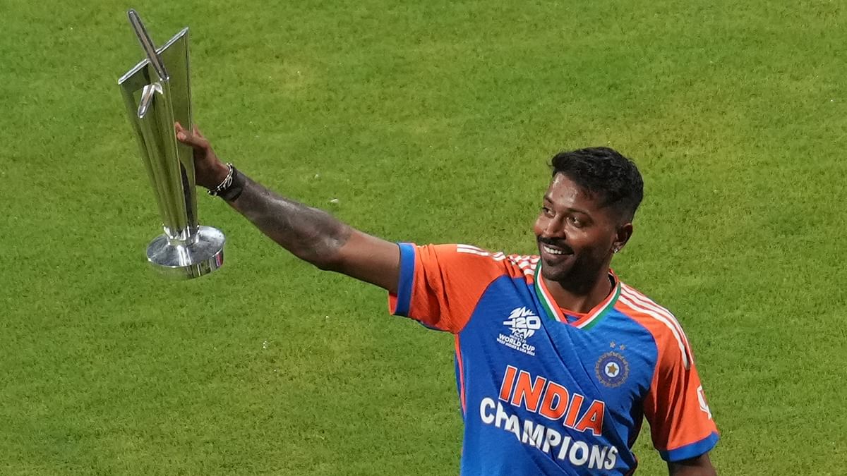 Hardik Pandya holds the championship trophy during a felicitation ceremony at the Wankhede Stadium, in Mumbai.