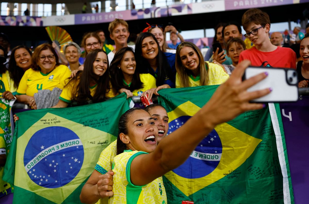 Antonia of Brazil takes a selfie with fans after the match.