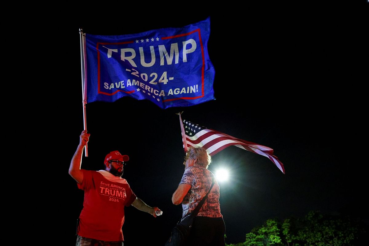 People gather after Republican presidential candidate and former U.S. President Donald Trump was injured when shots were fired, in Palm Beach.