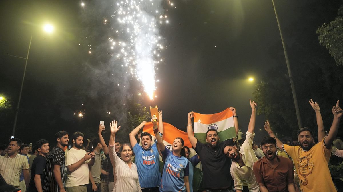 People celebrate on a road near the India Gate in New Delhi after India won the T20 World Cup 2024.