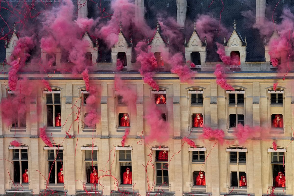 Smoke billows near windows as performers participate during the opening ceremony of the 2024 Summer Olympics, Friday, July 26, 2024. 