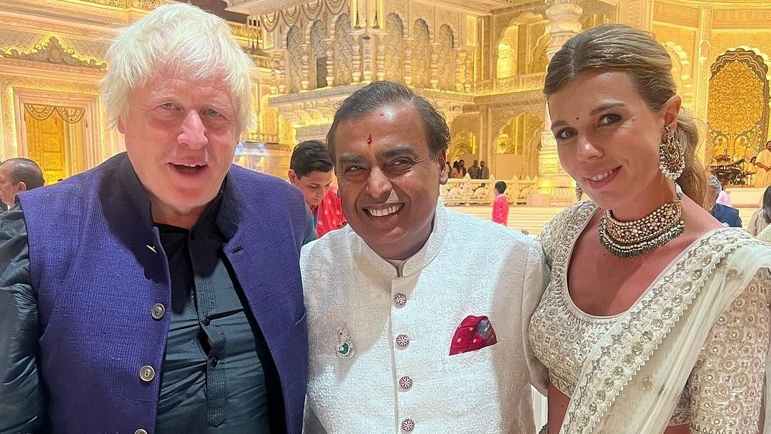 Former Prime Minister Boris Johnson and his wife Carrie pose with Mukesh Ambani.