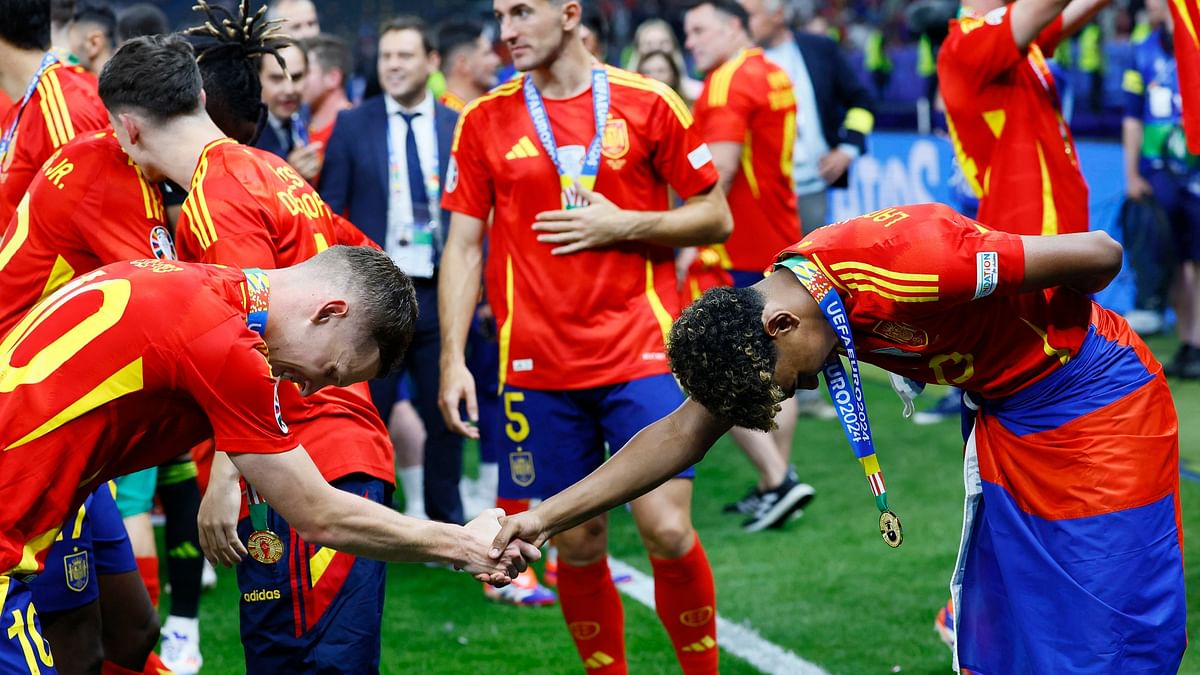 Spain's Lamine Yamal with Dani Olmo after winning Euro 2024.