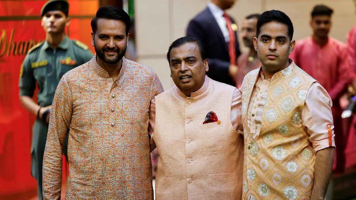 Mukesh Ambani flanked by his son-in-law, Anand Piramal, and son, Akash Ambani, during the pre-wedding ceremony of Anant Ambani and Radhika Merchant, at his residence in Mumbai.