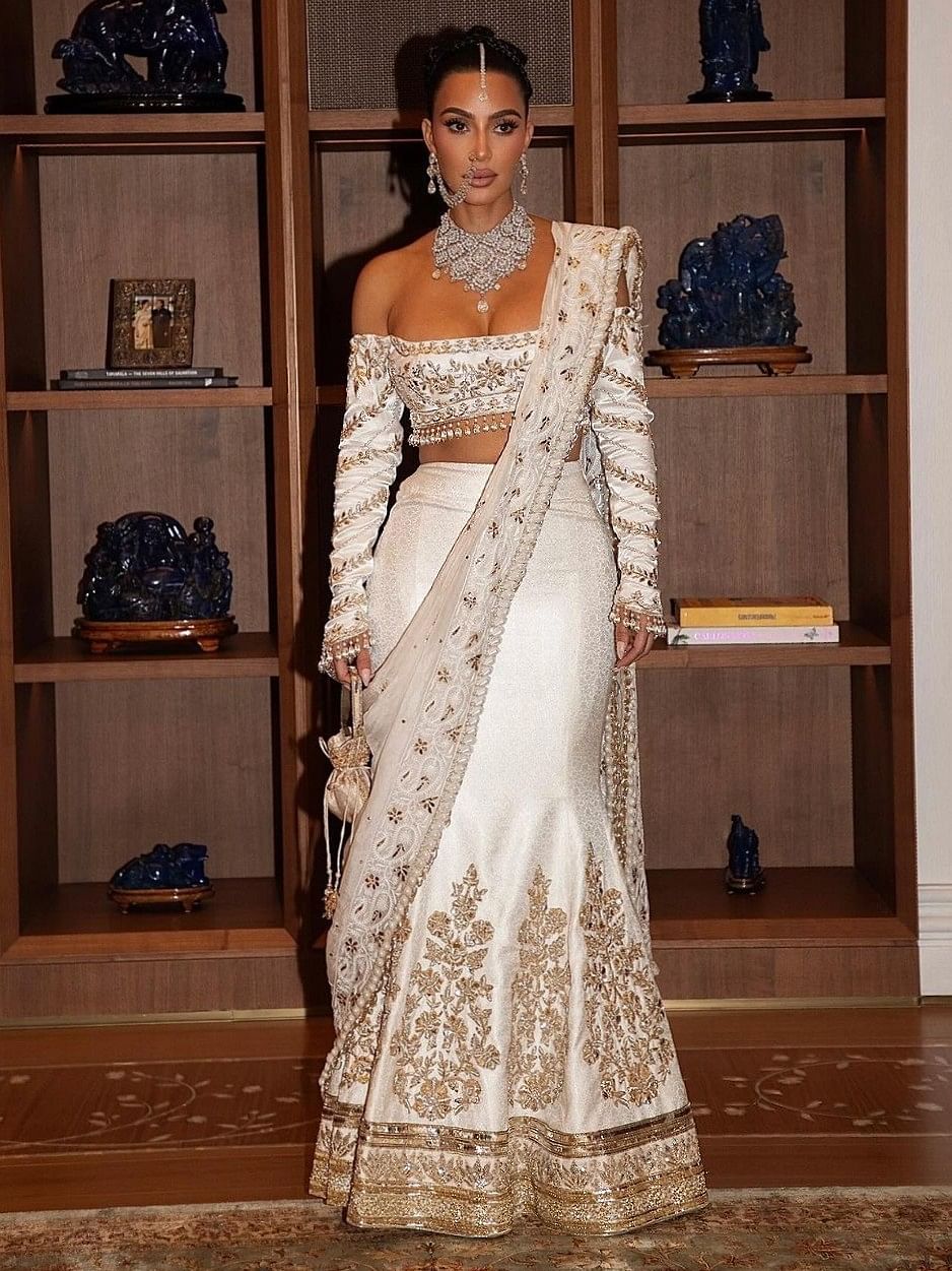 Kim's second outfit for the Ambani wedding was a custom Manish Malhotra ivory lehenga.