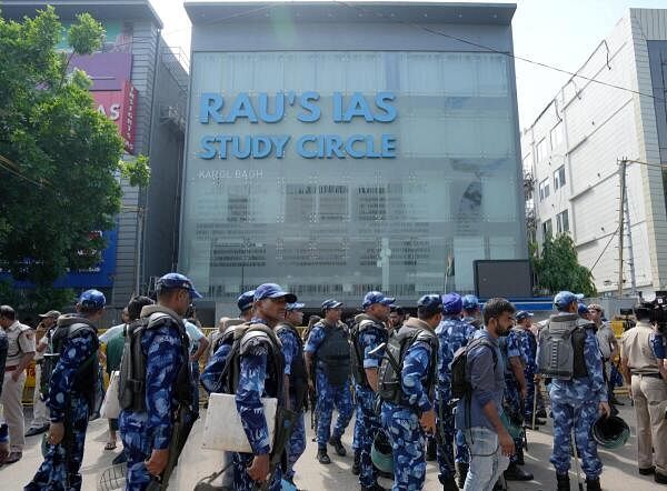 Security personnel stand guard near a UPSC exam coaching centre after three civil services aspirants died when the basement of the coaching centre was flooded following heavy rain, in New Delhi.