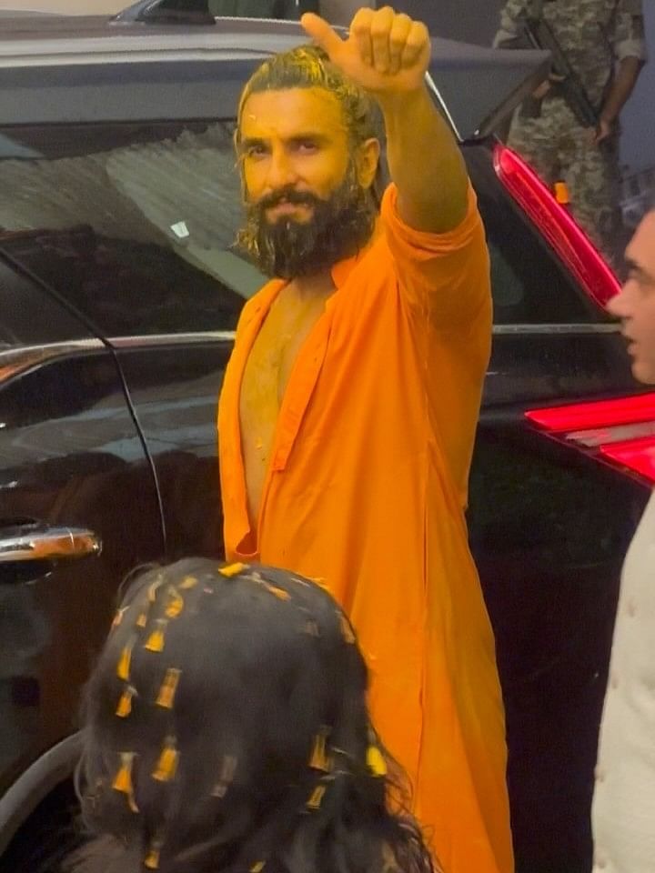 Ranveer Singh gestures as he departs after attending Anant Ambani and Radhika Merchant's Haldi ceremony.