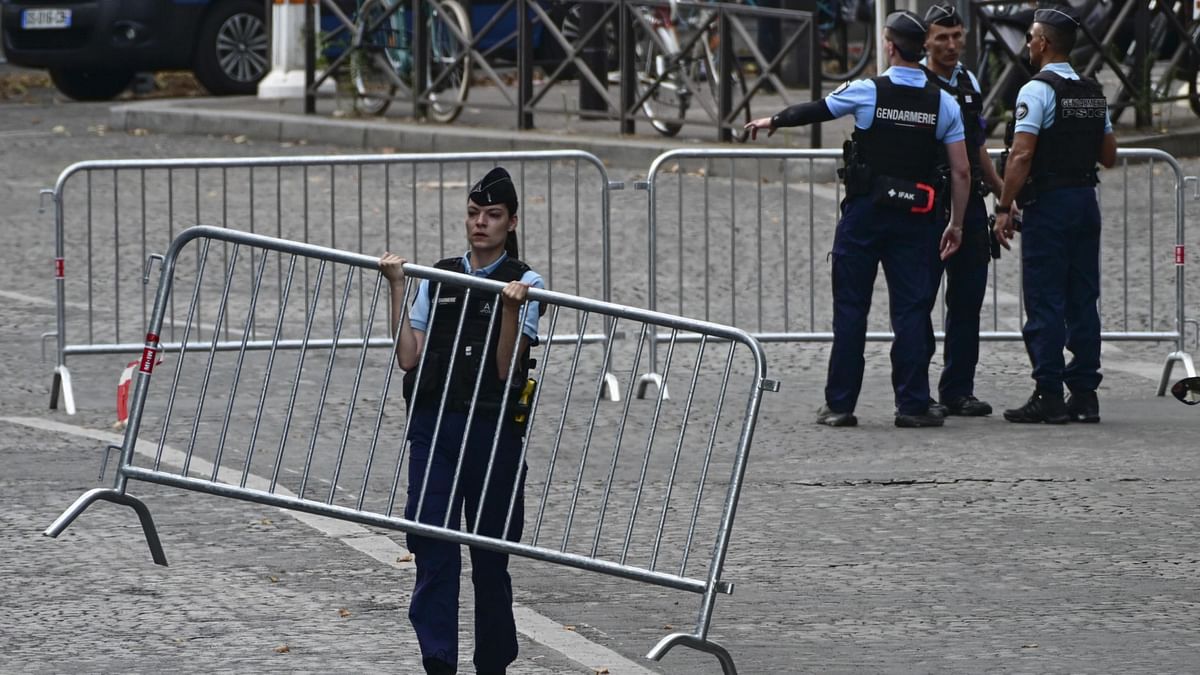 French policemen control the access at a checkpoint amid preparations for the opening ceremony of the Paris 2024 Olympic Games in Paris.