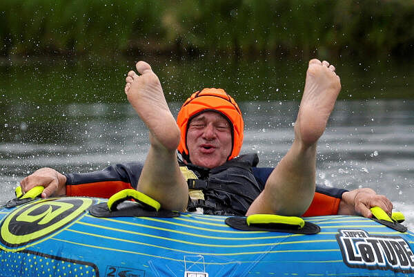 British leader of the Liberal Democrats party Ed Davey rides a towable inflatable during a visit to Lakeside Ski &amp; Wake, in Cotswolds, Britain, July 1, 2024.