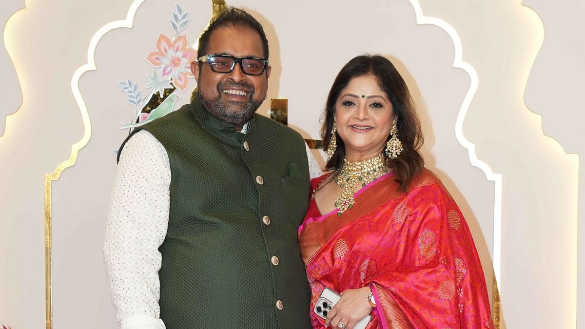 Music composer Shankar Mahadevan poses with his wife on their arrival for Anant Ambani and Radhika Merchant's wedding.