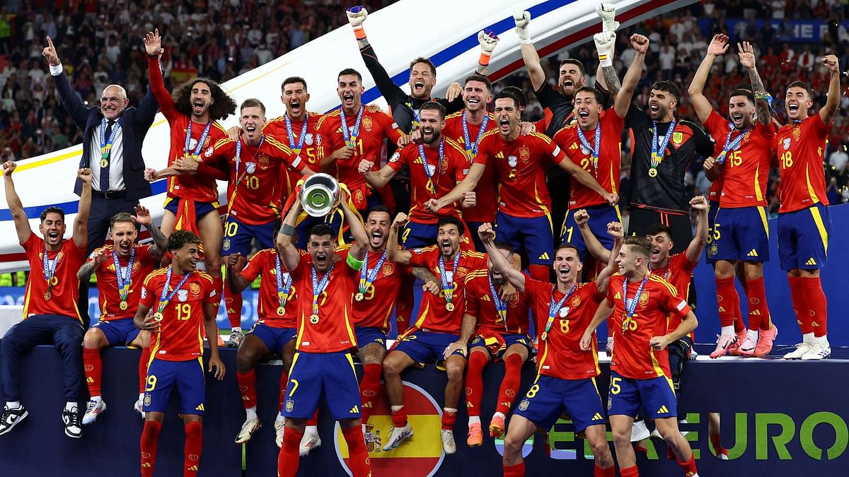 Spain's players celebrate with the trophy after winning the final match between Spain and England at the Euro 2024 soccer tournament in Berlin, Germany.