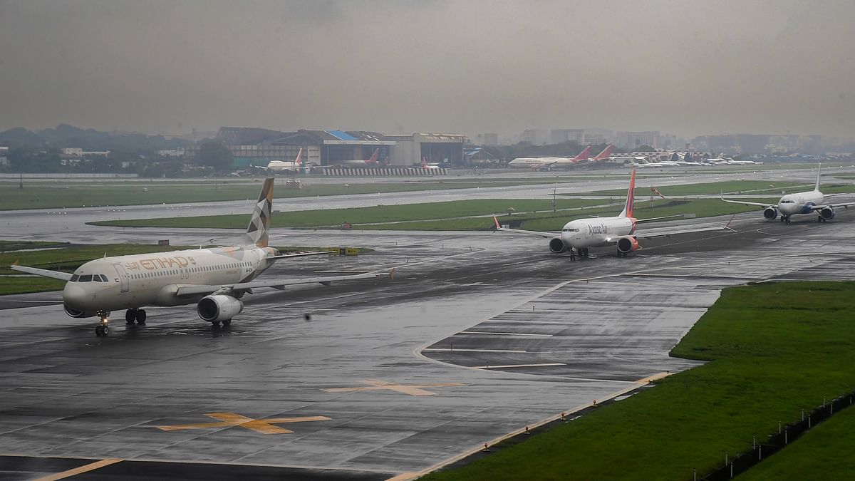 Planes  on the wet tarmac at the airport in Mumbai.