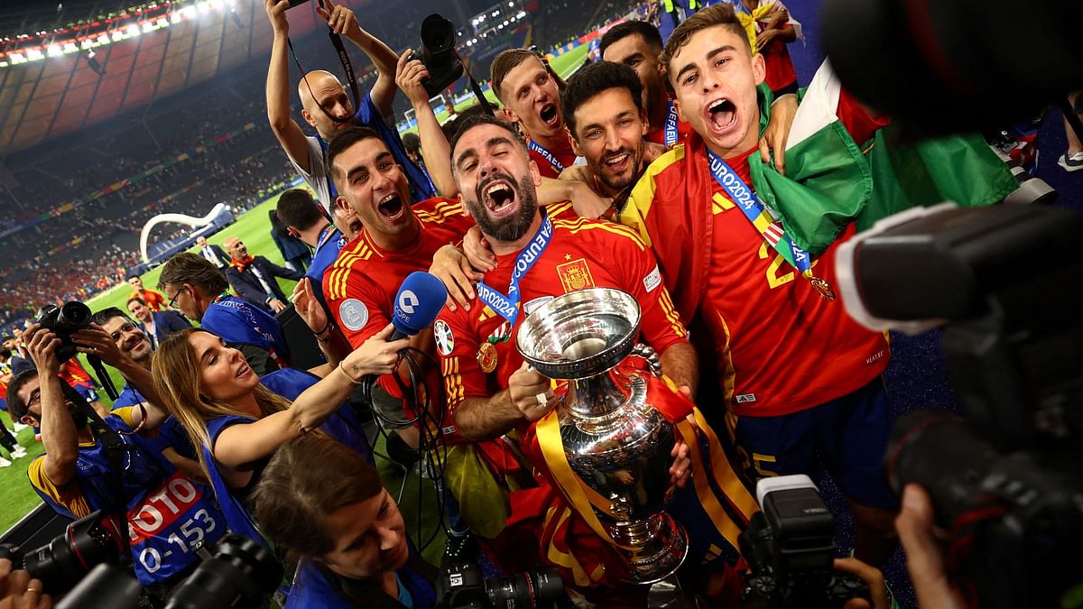 Spain's Dani Carvajal, Ferran Torres, Jesus Navas, Fermin Lopez and teammates celebrate with the Euro 2024 trophy.