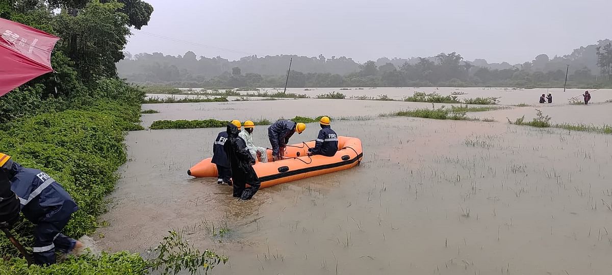 CESC personnel travel in a boat to reach out to the areas hit by power disruption.