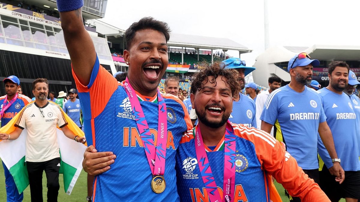 Hardik Pandya and Kuldeep Yadav celebrate with the trophy after winning the T20 World Cup.