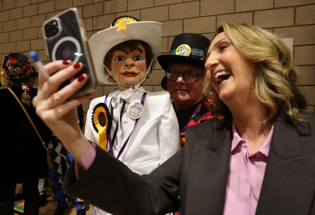 A member of the Official Monster Raving Loony Party dressed in costume poses for a photo as staff count ballot papers for Richmond and Northallerton during the UK election in Northallerton, Britain.