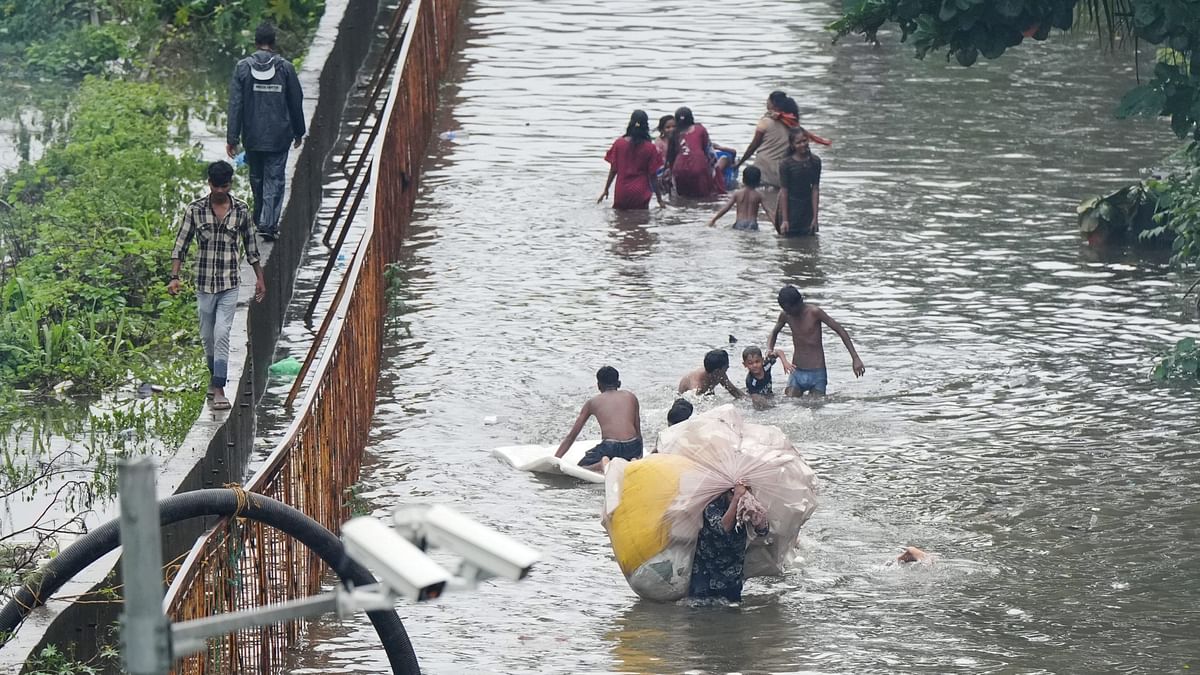 People make their way through a waterlogged street following rains in Mumbai.