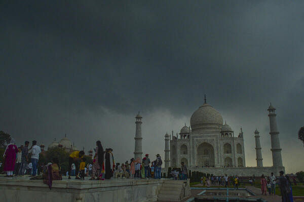 Dark monsoon clouds hover above the Taj Mahal in Agra on July 9, 2024. 