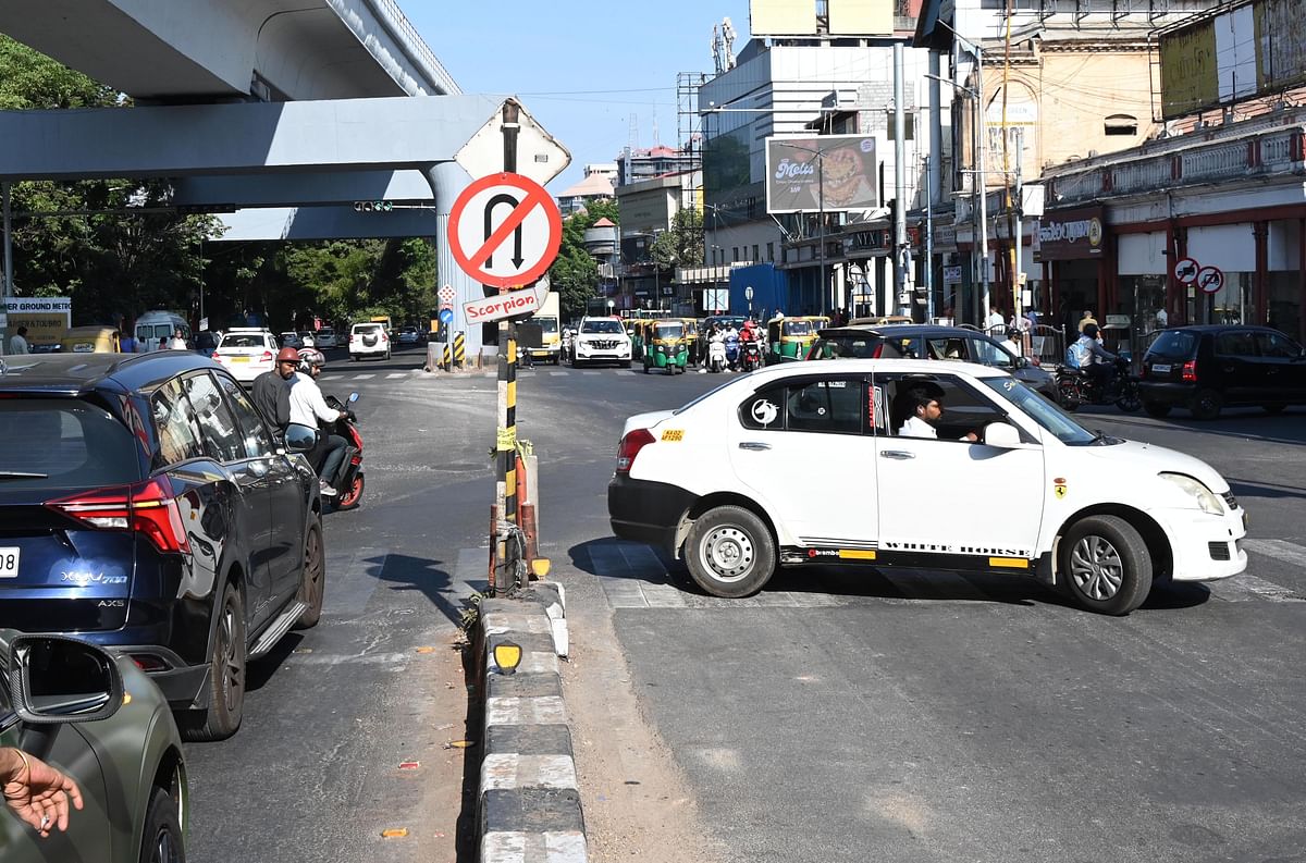 A driver takes a U-turn where it is specially prohibited on a busy stretch along M G Road. 